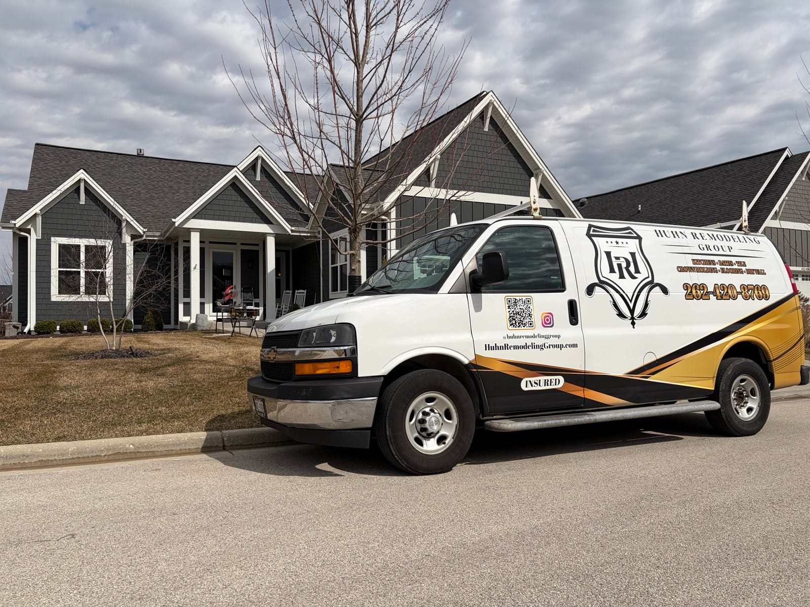 Huhn Remodeling Group van at a craftsman-style home