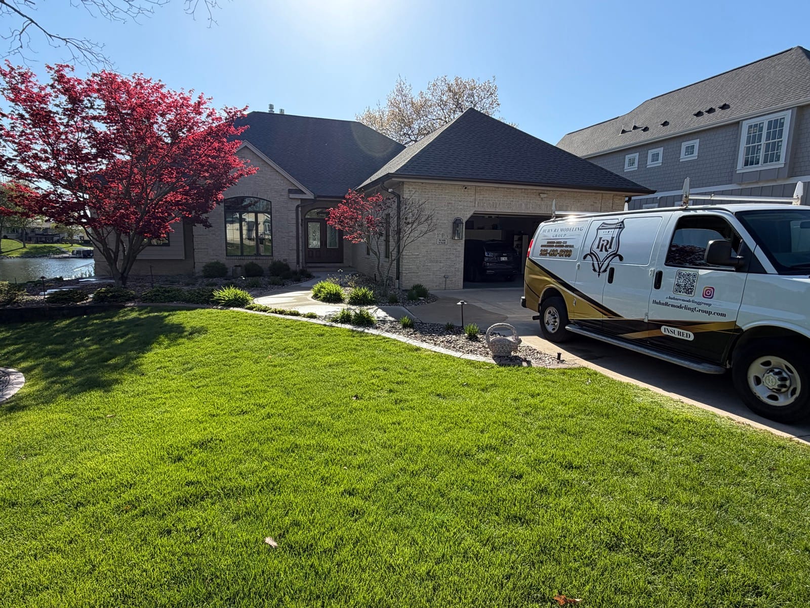 Huhn Remodeling Group van at a lakeside project
